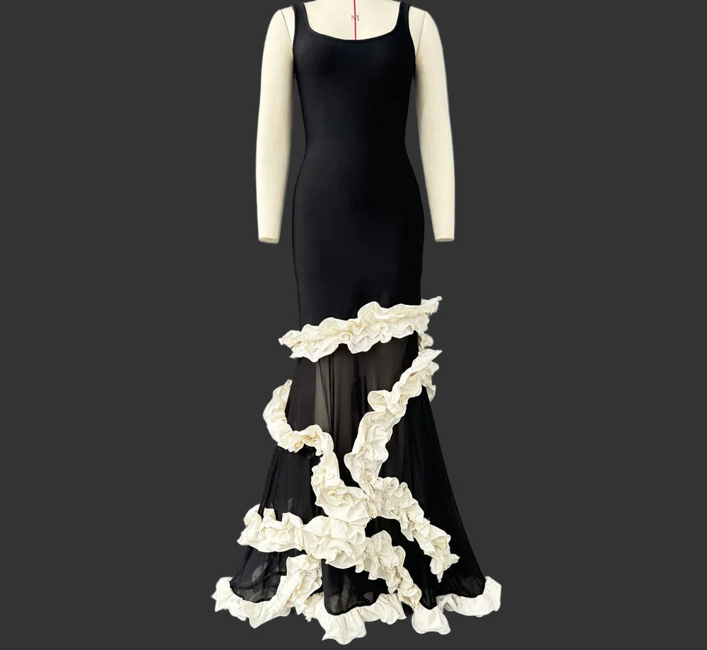 Black dress with white floral details on a mannequin against a gray background